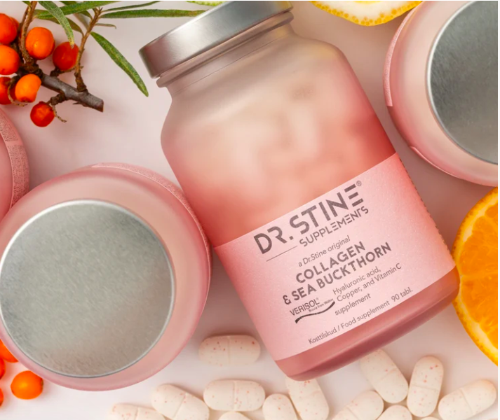 Dr. Stine Supplements collagen with sea buckthorn jar surrounded by berries and orange slices